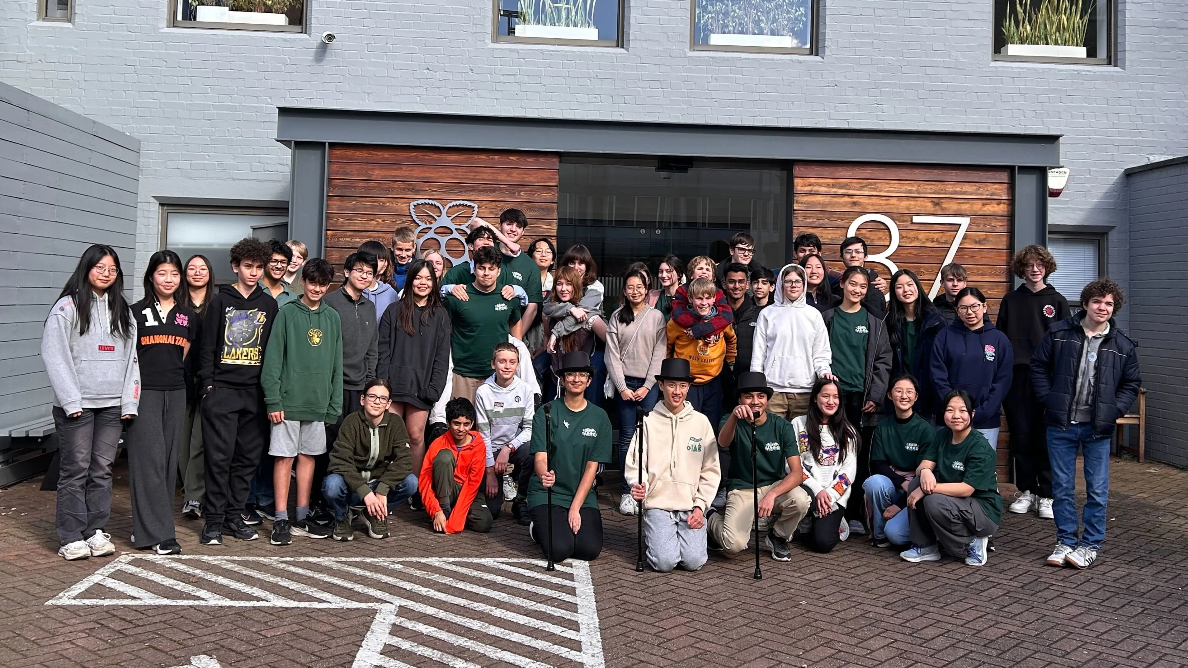 A large group of teenagers stood in front of the Raspberry Pi Foundation office