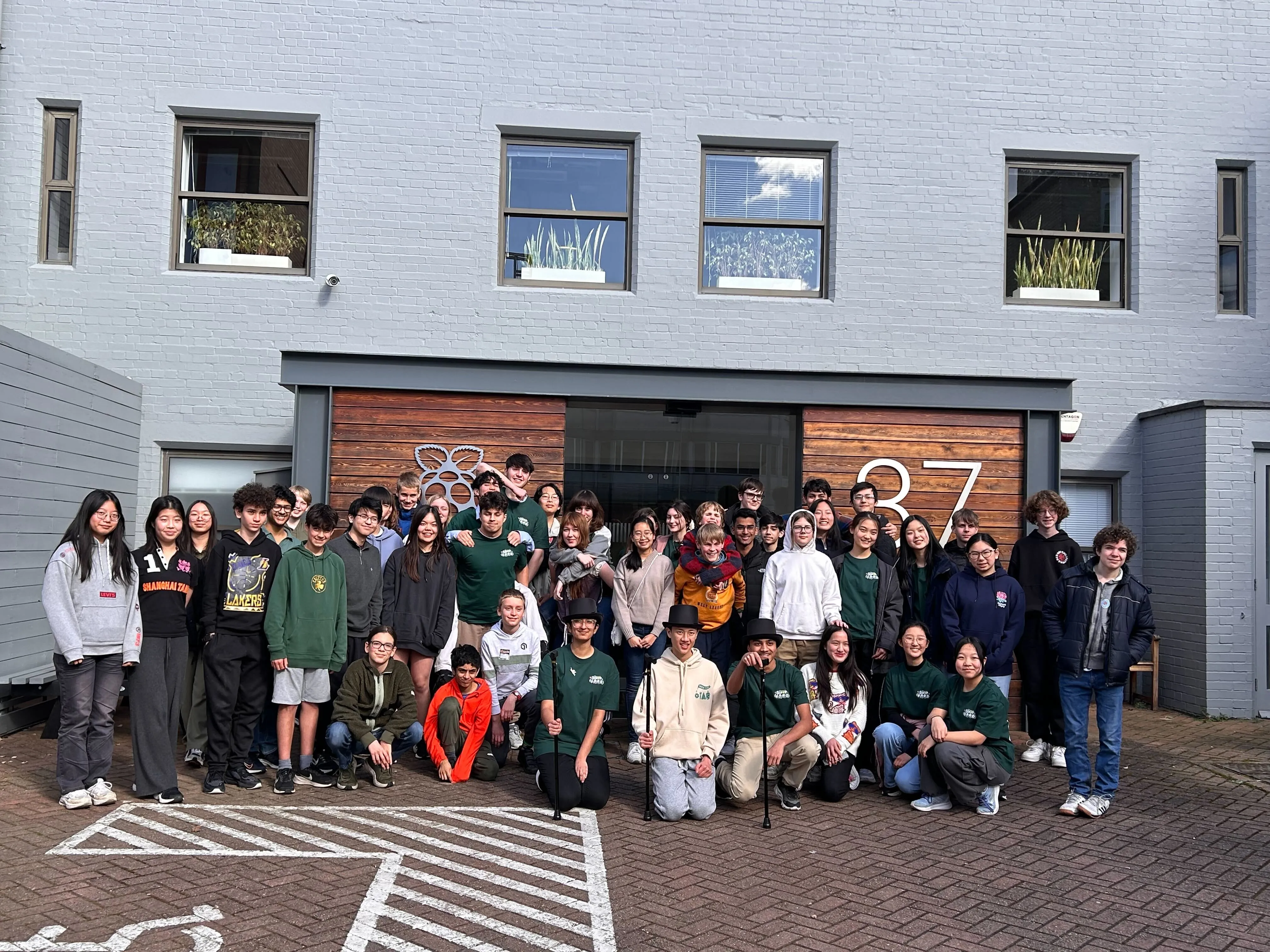 A large group of teenagers stood in front of the Raspberry Pi Foundation office